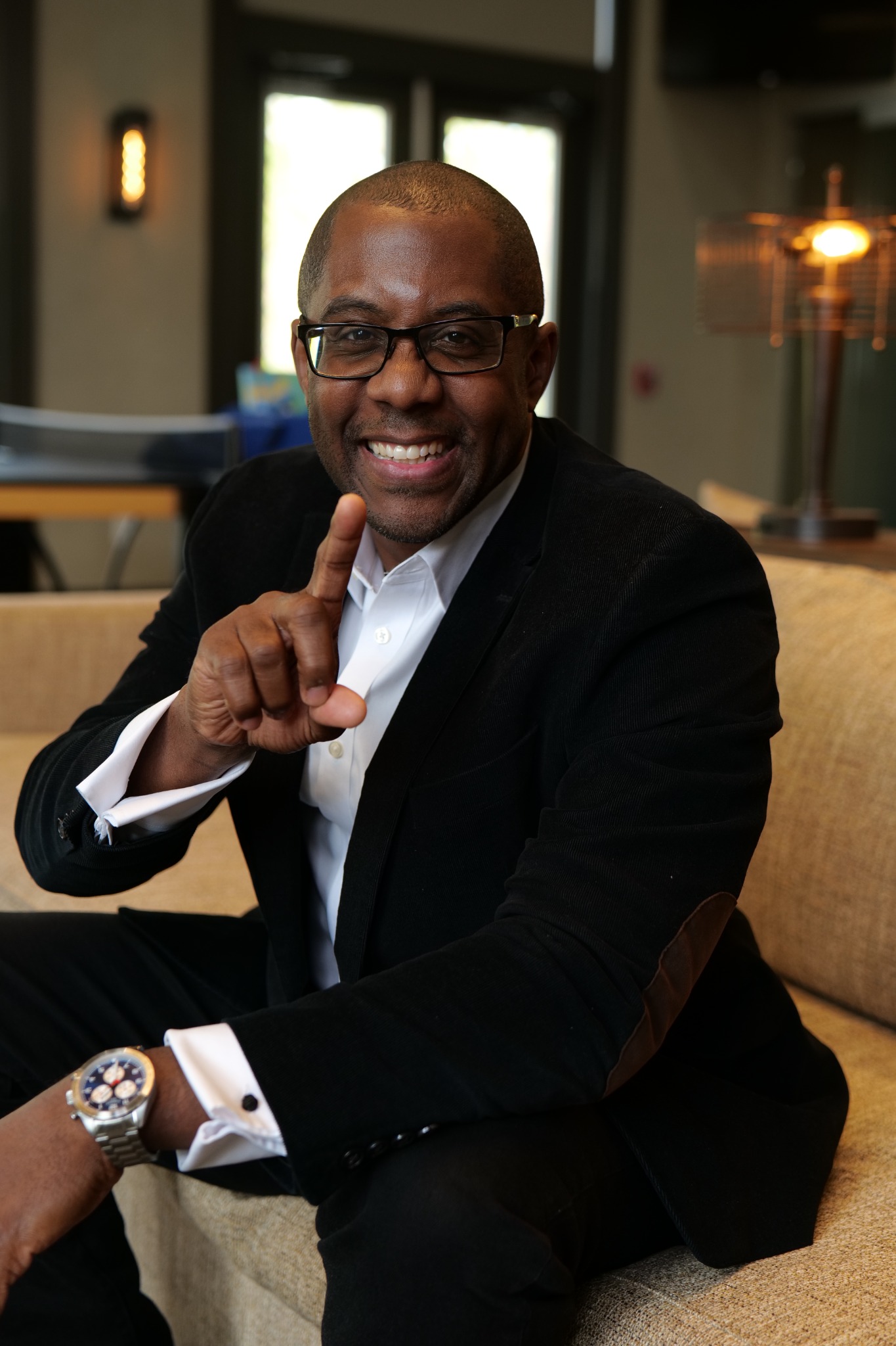 Ramon Ray smiling and gesturing toward the viewer